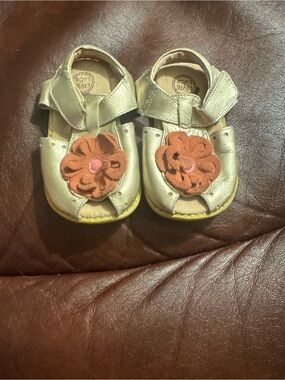 Livie & Luca Metallic Gold Leather Sandals with Flower Accent